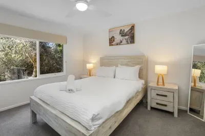 Bedroom Retreat: Serenity awaits in this sunlit room with nature views and stylish decor!