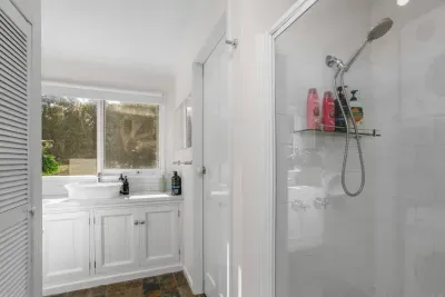 Bathroom Sanctuary: Light-filled retreat with modern fixtures and serene garden views!