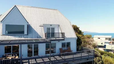 Coastal A-frame with wraparound deck and sweeping ocean views