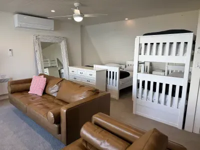 Spacious family room with bunks, single beds, and cozy lounge seating