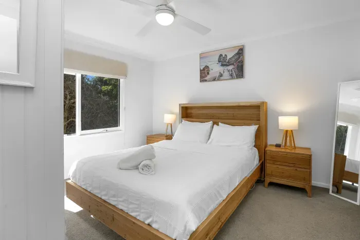 Relax in the comfortable second bedroom, with a queen bed and peaceful coastal styling.