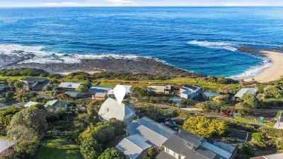 Aerial view of Marengo Views (pinned) — perched above the Marengo Reef Marine Sanctuary with Harrison’s Beach steps away and the Southern Ocean stretching to the horizon.