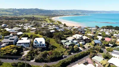 Elevated coastal stay with panoramic ocean views, walk to beach