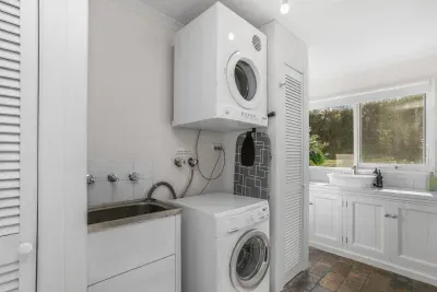 Laundry Room: Sleek appliances and a sunny view make chores a breeze in this functional space!