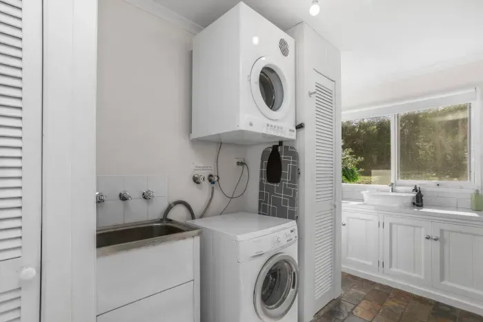 Laundry Room: Sleek appliances and a sunny view make chores a breeze in this functional space!