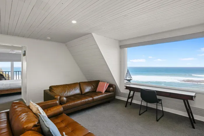 Unwind in the upstairs retreat, with a dedicated workspace and sweeping Southern Ocean views.