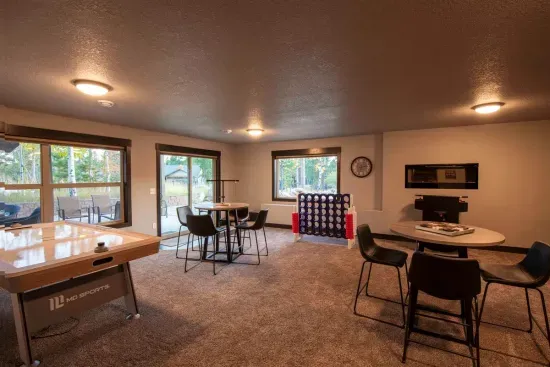 The ultimate hangout spot—recline by the big screen, sip drinks by the electric fireplace, challenge friends at the arcade, or gather around the table for games and laughs.