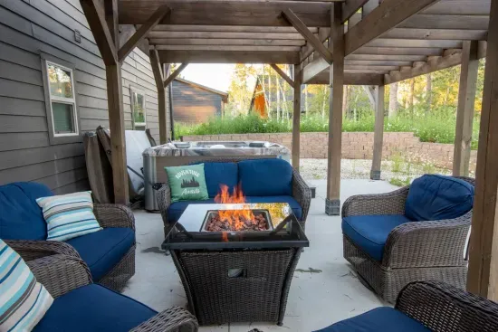 Start your day with coffee and end it with drinks—this cozy covered patio features a firepit, hot tub, and plush seating for stargazing, laughter, and relaxation.