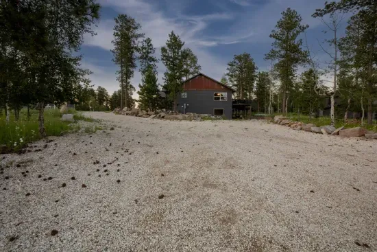 Plenty of space for trailers, ATVs, and multiple vehicles—this oversized driveway makes arrivals, unloading, and adventure prep easy and stress-free.
