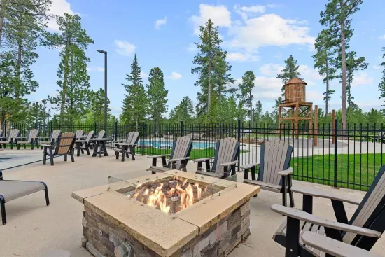 Unwind around the firepit, lounge in Adirondack chairs, or watch the kids explore the water tower playground—just part of the fun at the Powder House Pass clubhouse.