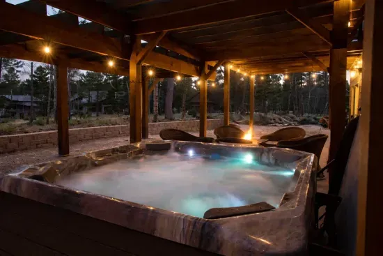 Hot tub under the lights with a fire glowing nearby. After a day exploring the Black Hills, this is where everyone ends up.