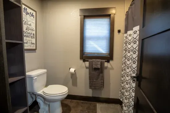 The lower-level bath features a separate toilet and shower area—ideal for added privacy and convenience when sharing the space with others.