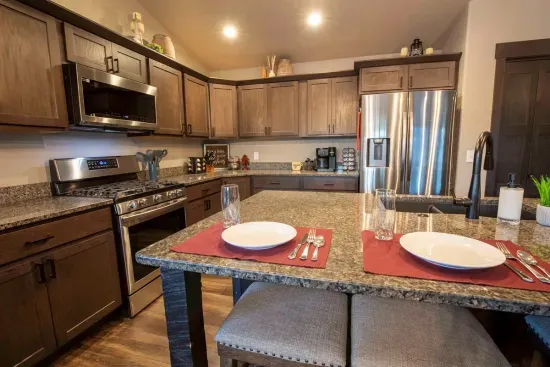 "On The Rocks" provides a powerful gas stove, stainless steel appliances, and a spacious granite island with bar stools in it's gourmet kitchen.
