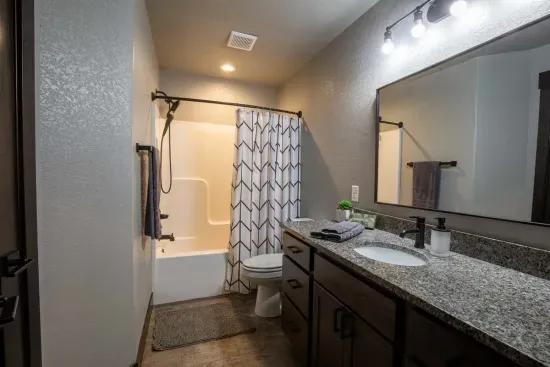 This main floor full bath offers a spacious granite vanity, bright lighting, and a shower/tub combo—perfect for freshening up after a day on the trails.