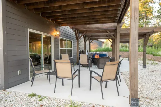 Relax on the covered patio with evening drinks by the firepit, soak in the nearby hot tub, or gather for stargazing and conversation in this inviting outdoor space.