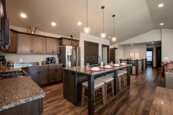 Imagine gathering in the bright open-plan space at "On The Rocks," lounging on the plush sofa, sharing meals at the dining table, or chatting at the granite island bar.