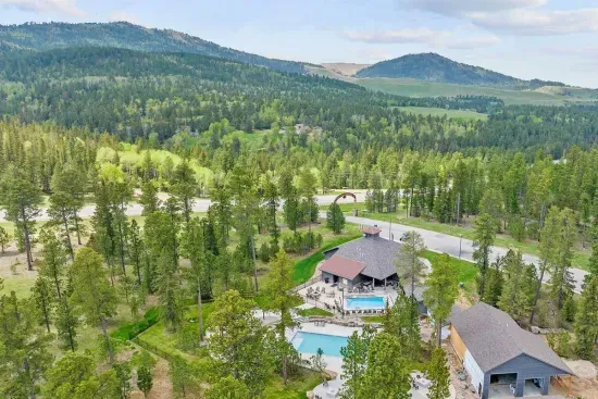 A stunning aerial of the PHP clubhouse nestled in the Black Hills—featuring two heated pools, scenic views, and endless space to relax, explore, and connect with nature.