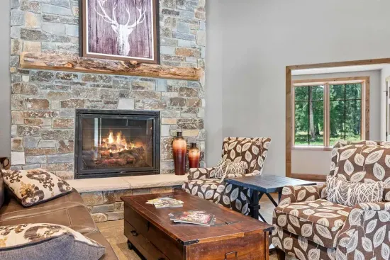 Cozy up by the fire in the Powder House Pass clubhouse—this welcoming lounge is the perfect spot to relax with a book, chat with friends, or escape the chill after a day of adventure.