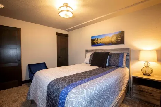 Relax in this cozy lower-level queen bedroom—perfect for guests seeking a quiet, private space to unwind after a full day of Black Hills adventure.