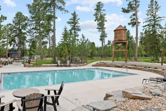 One of two heated outdoor pools at Powder House Pass—ideal for a refreshing dip or a relaxing soak, all surrounded by pine trees and mountain air. Just minutes from the cabin.