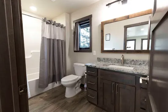 Full bathroom upstairs with granite vanity and tub/shower. Private access from the king bedroom plus a second door from the loft for the bunk room.