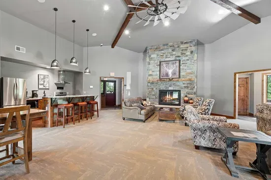 Inside the Powder House Pass clubhouse you'll find a spacious gathering area with a fireplace, seating, and kitchenette—perfect for relaxing after a day of adventure in the Black Hills.