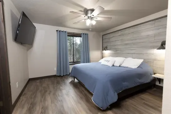Lower-level king suite with forest views, smart TV, and a private ensuite bathroom. A quiet retreat perfect for relaxing after a day exploring the Black Hills.