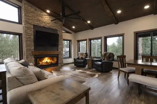 The great room. Big windows, a stone fireplace, and a spot where everyone ends up after a day in the Hills.
