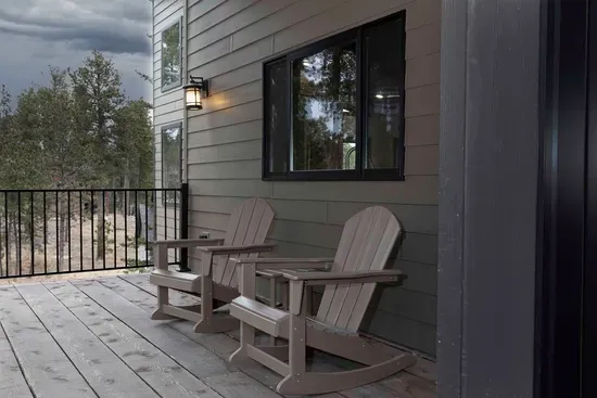 Before you even step inside, take a moment. Two chairs, quiet forest air, and the feeling that the pace of life just slowed down.