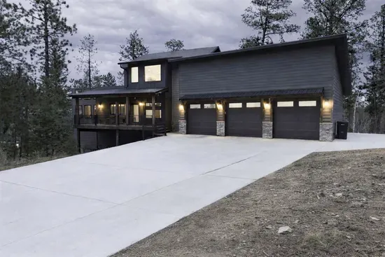 When you pull up to Quittin’ Time you’ll notice one thing right away… plenty of space. Big driveway, heated garage, and a peaceful spot tucked into the pines.