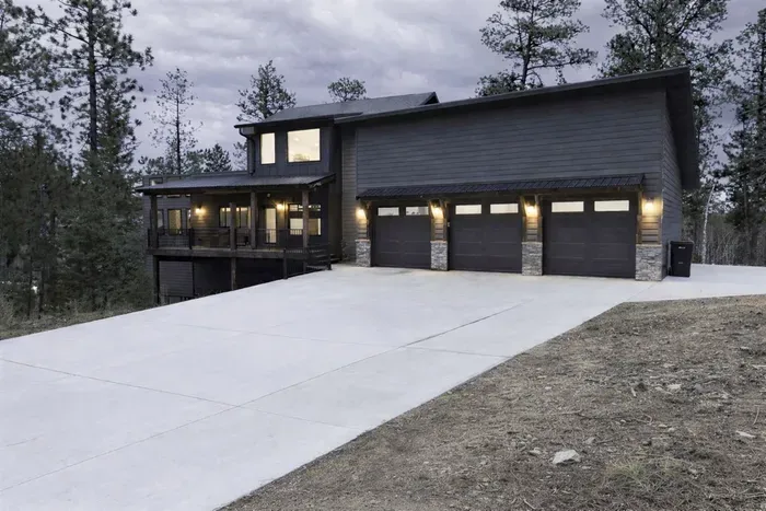 When you pull up to Quittin’ Time you’ll notice one thing right away… plenty of space. Big driveway, heated garage, and a peaceful spot tucked into the pines.