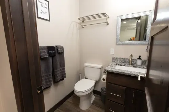 Upper-level half bath located off the loft, providing easy access for the bunk room and upstairs guests.