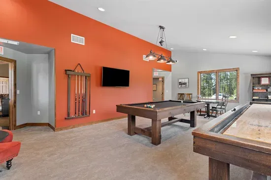 Take a break from the trails and enjoy the Powder House Pass clubhouse game room featuring pool and shuffleboard tables in a comfortable shared space.