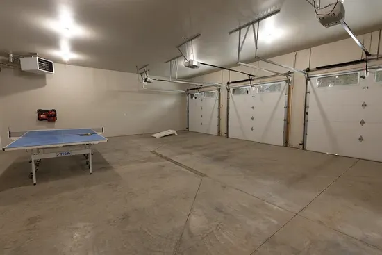 The garage doubles as a play zone—ping pong, cornhole, and plenty of room to hang out while the rest of the crew relaxes inside.