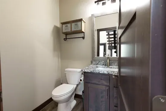 Clean and modern main-level half bath with granite vanity at Quittin’ Time. Easy access from the main living area.