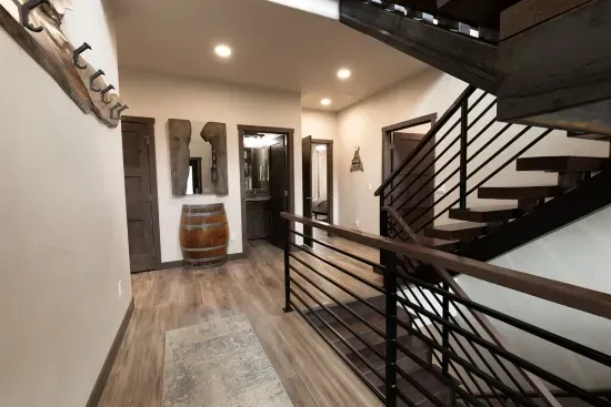 Welcoming entryway at Quittin’ Time with a modern staircase connecting all levels of the home. Easy access to bedrooms and living spaces makes the layout comfortable for groups.