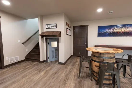 Hidden kids play space tucked under the stairs—perfect for little explorers while the adults relax in the game room nearby.