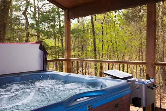 Slip into the hot tub, let the bubbles do their thing, and forget what day it is. Tucked into the trees with nothing but quiet around you, this is where mornings start slow and evenings last a little longer. Cold drink within reach, string lights overhead,