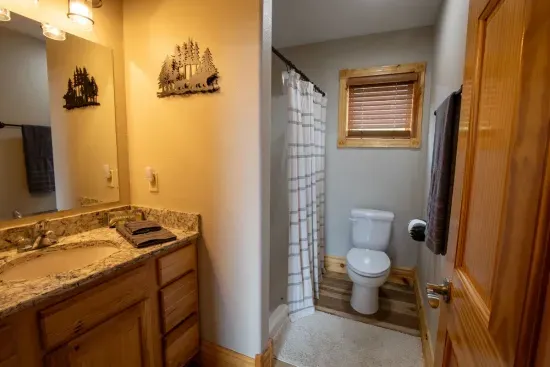 The main floor full bath features plenty of counter space, making it perfect for getting ready for a night out or preparing for a day of adventure.