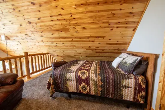 The loft features a comfortable queen bed, creating a cozy and private getaway.
