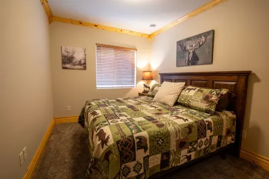 The lower level bedroom features a comfortable king bed, perfect for a relaxing night's sleep.