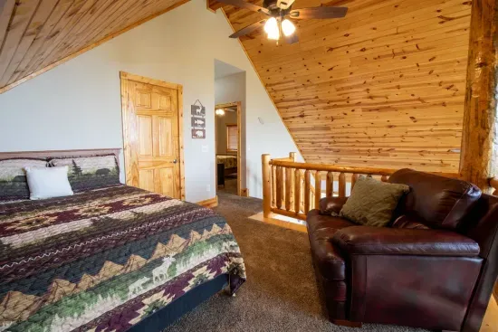 The loft features a cozy queen bed, offering a peaceful retreat with a unique, elevated view.