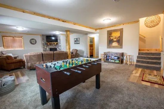 The lower-level living room, complete with games, offers the ideal spot to relax and enjoy some friendly competition.