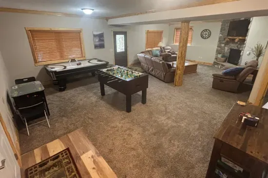 Kick back and relax in this warm, open-concept lower level — complete with cozy leather seating, a stone fireplace, and plenty of space for everyone to spread out.