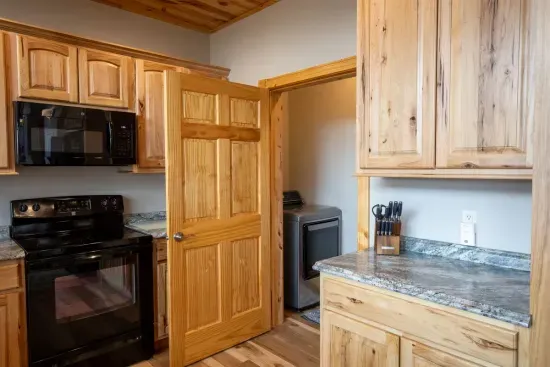 The laundry room is conveniently situated just off the kitchen on the main floor, making it easy to freshen up during your stay.