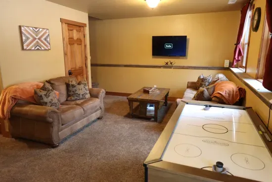 The lower level living room is a great space for people to split up to play air hockey, watch a movie or to challenge themselves on the retro arcade table.