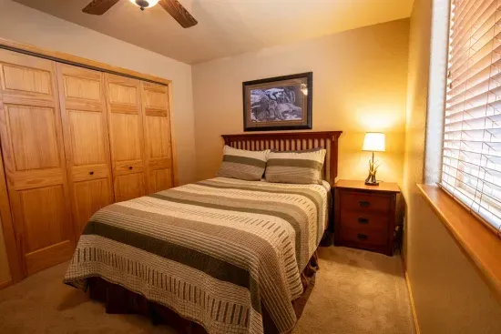 The downstairs queen bedroom is spacious and inviting, guaranteeing a restful night's sleep for your stay.