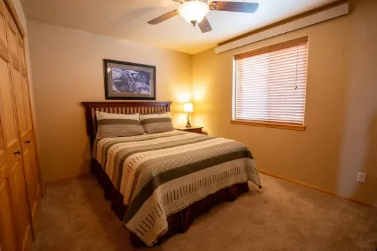 Enjoy a restful night’s sleep on the comfortable queen bed in the downstairs bedroom, perfect for recharging after a day of adventure.