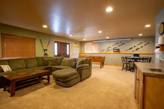 The lower level living room is spacious and ideal for unwinding after a day of adventure in the Black Hills, providing a comfortable space to relax and recharge.