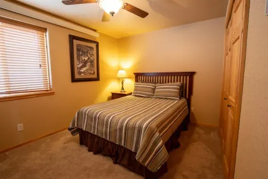 The second downstairs queen bedroom provides a tranquil setting for a restful night's sleep, ensuring you’re recharged and ready for another day of adventure in the Hills.